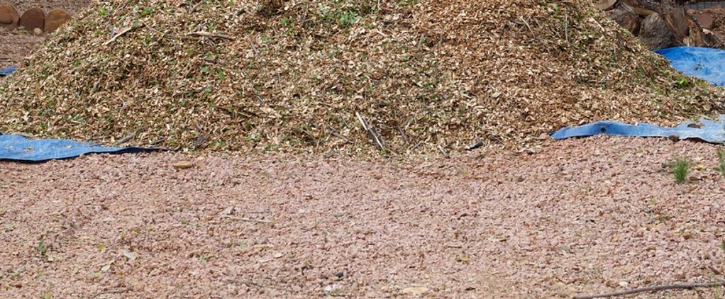 A mulch pile with cut log rounds (stock photo, not this yard) by Brimfield Aggregate, Brimfield